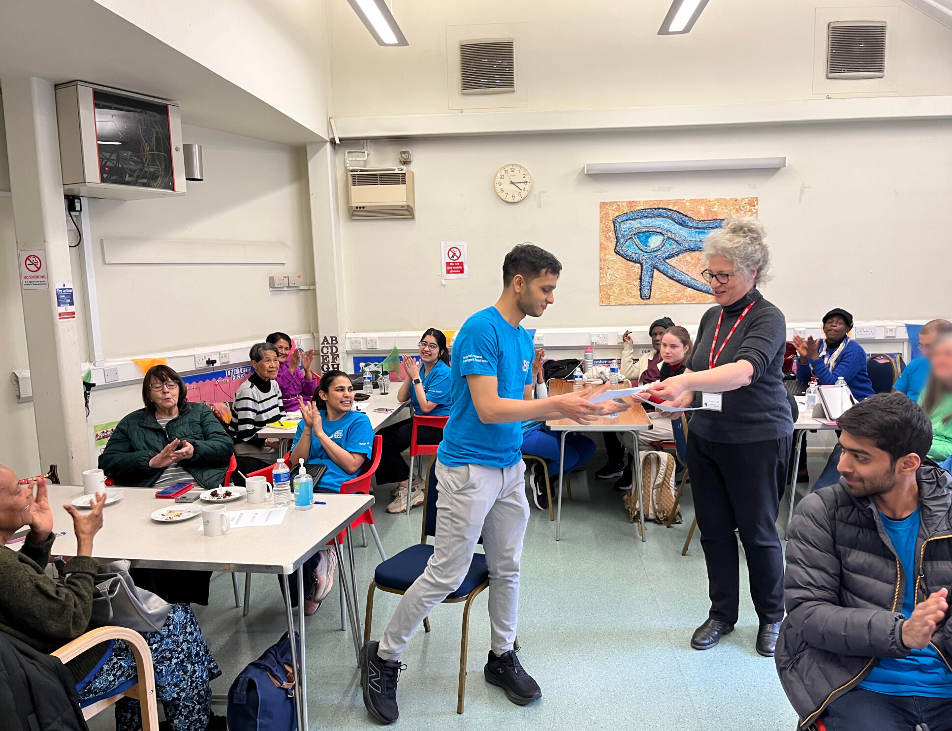 Ayan Modi (Imperial Business School Student Volunteer) being given his certificate by Masbro Elders Project Manager Tina Wood