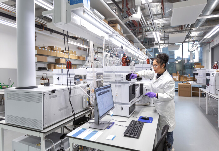 A scientist takes measurements with instruments inside the Agilent Measurement Suite.