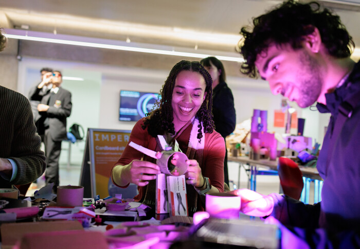 Visitors interacting with an activity at Imperial Lates: Future Cities