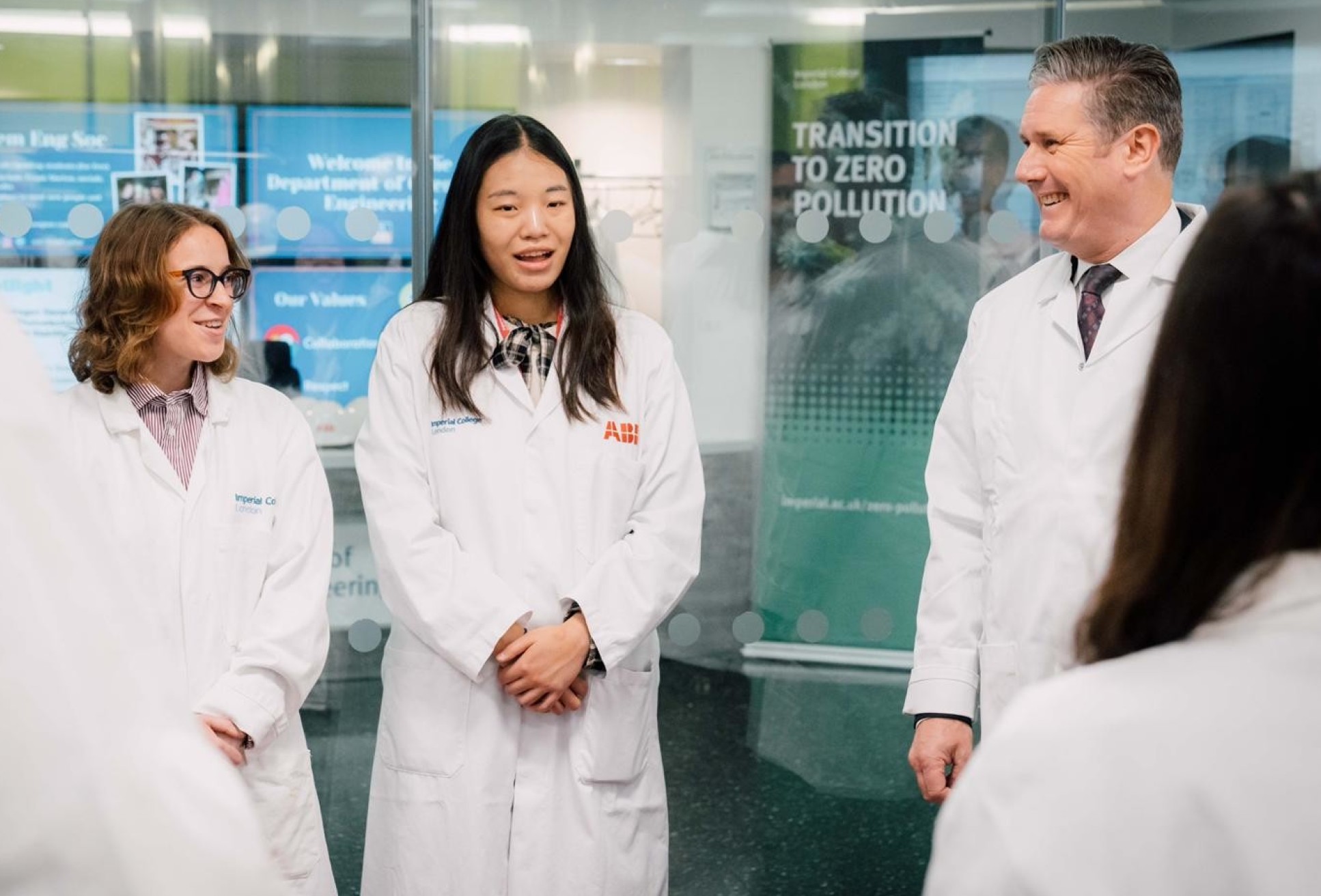 People in labcoats smiling