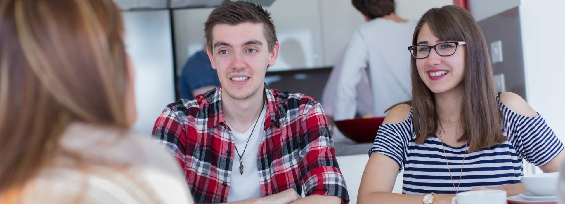Students relaxing in shared living space in halls